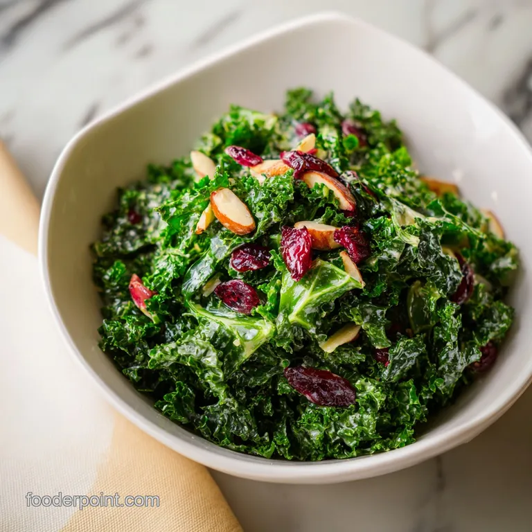 A generous scoop of kale salad crowned with toasted nuts and a drizzle of dressing on a white plate.